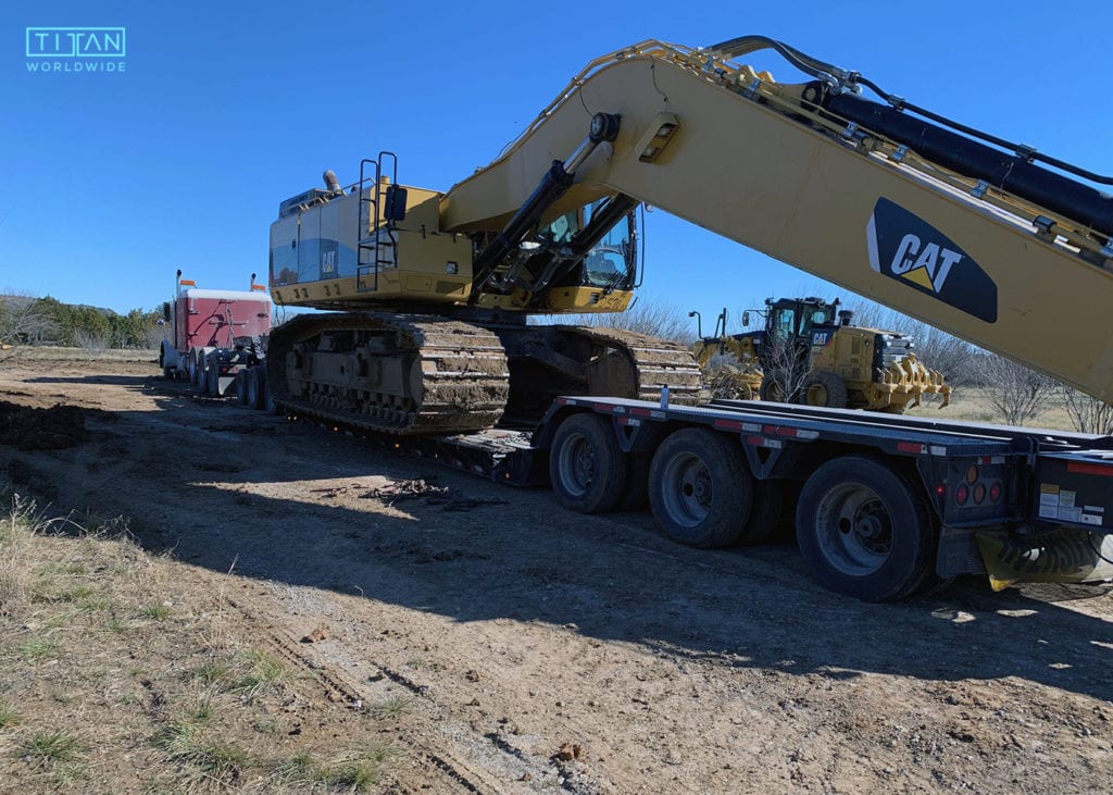 heavy haul truck with a Caterpillar 3900 GAL excavator on trailer