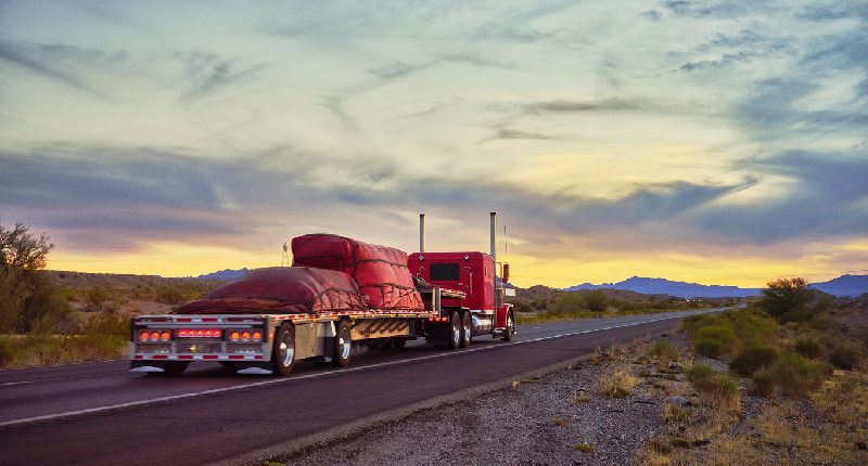 truck pulling a flatbed trailer