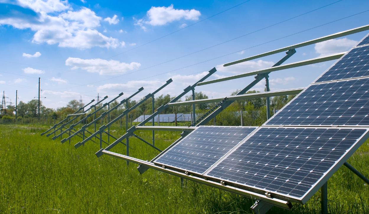 Partially installed row of solar panels in a field