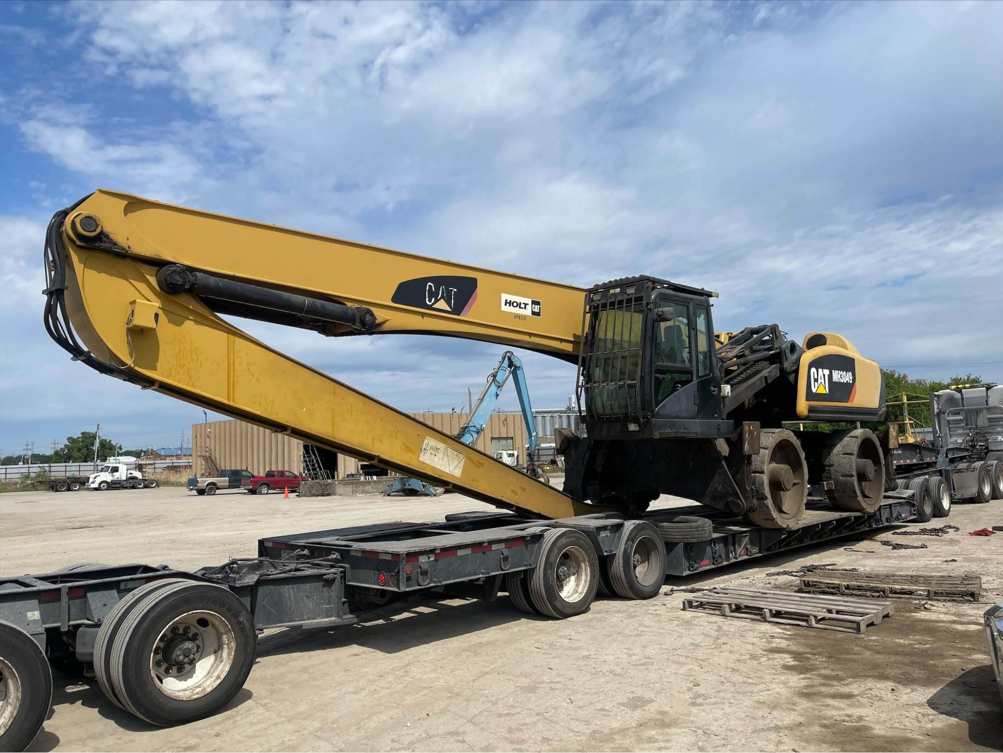 Yellow Cat MH3049 material handler on transport trailer.